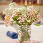 pink and white wild flowers placed in a mason jar